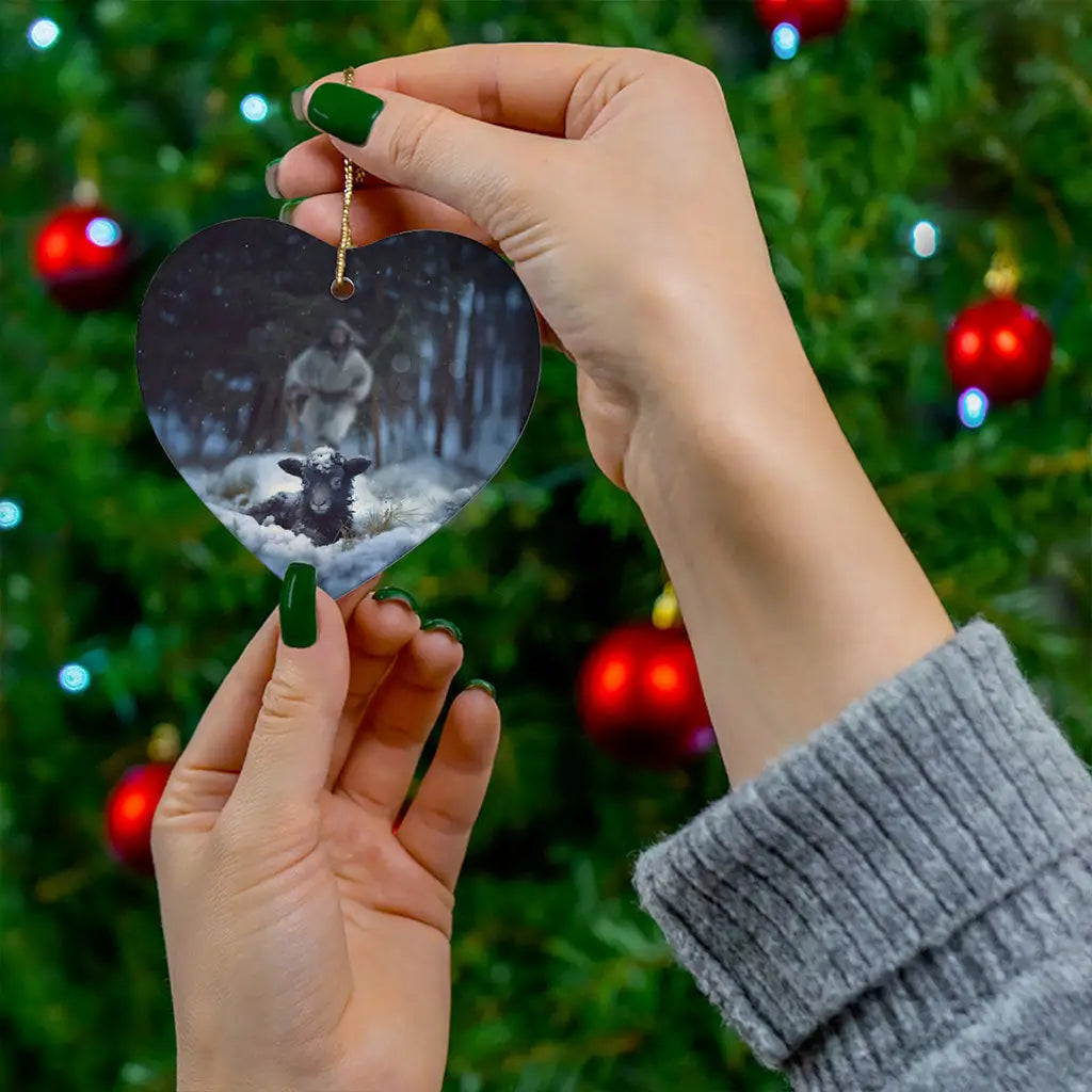 Inspirational ornament of Jesus in a snowy forest saving a sheep, perfect for Christmas decor.