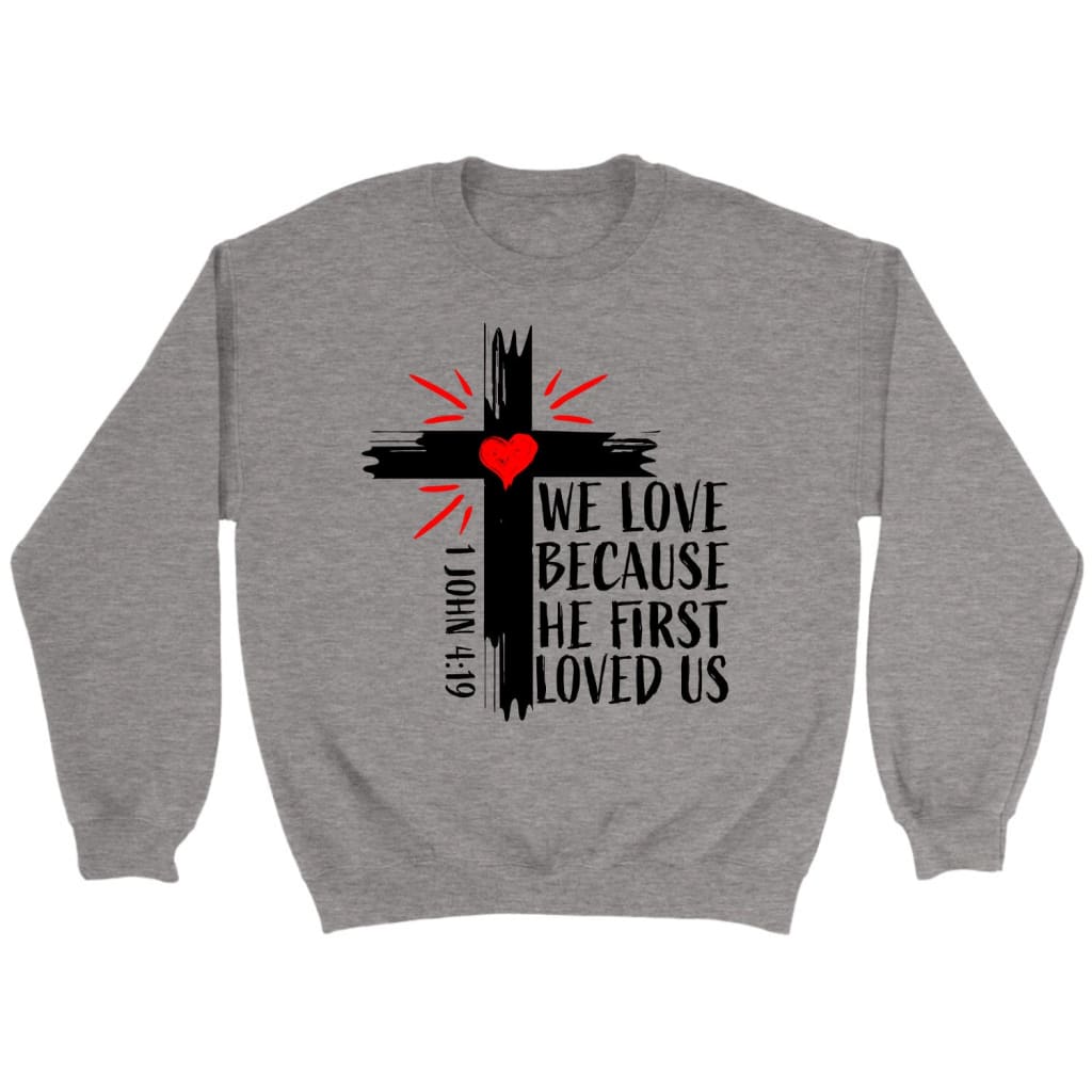 Christian sweatshirts: 1 John 4:19 We love because He first loved us sweatshirt Sport Grey / S