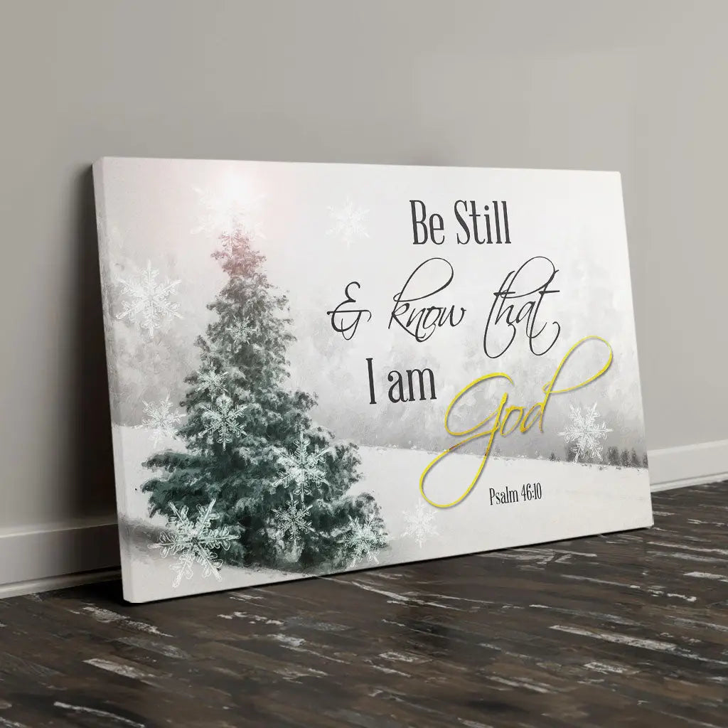 Be Still and Know That I Am God wall art canvas featuring snowy hill and evergreen tree.