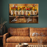 Inspirational canvas with "Be still and know that I am God," Psalm 46:10, adorned with a charming mason jar floral design.