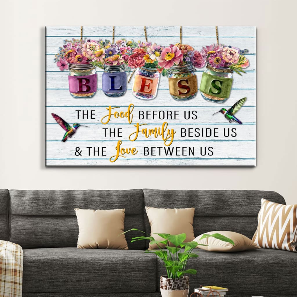 Inspirational canvas print with "Bless the Food Before Us" and flowers in jars, ideal Christian gift for home decor.