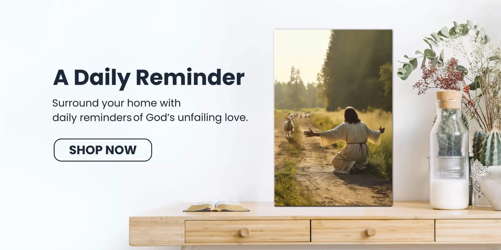 A canvas print depicting Jesus kneeling on a dirt path with arms outstretched towards sheep.