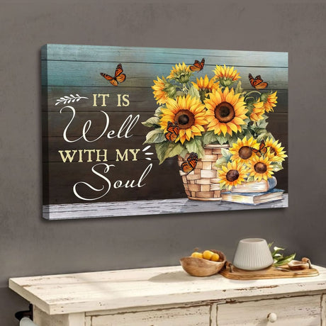 Christian wall art canvas featuring a vibrant pot of sunflowers and fluttering butterflies with the comforting phrase "It is Well With My Soul," perfect for gifts.