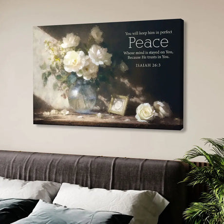 Christian wall art with Isaiah 26:3, "You will keep him in perfect peace," featuring white roses in a glass vase under soft sunlight.