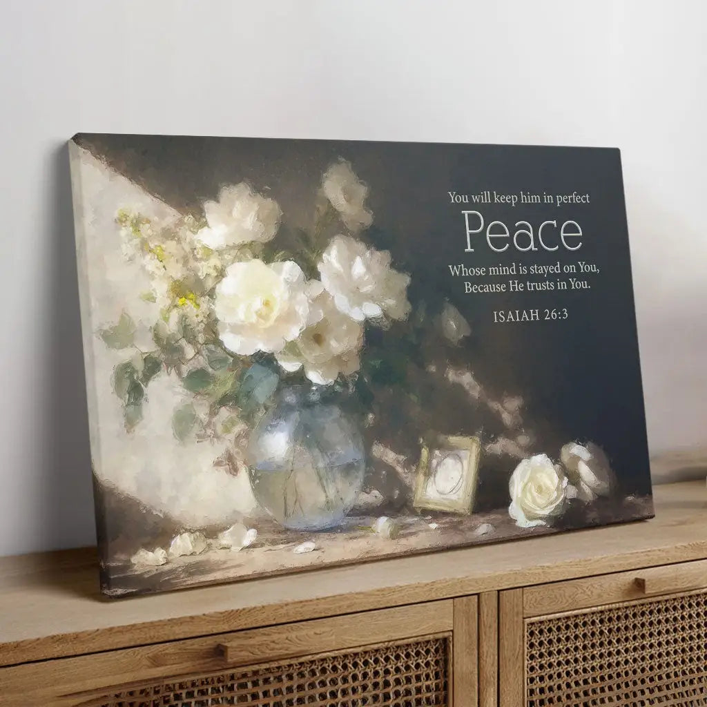 Inspirational canvas with Isaiah 26:3, "You will keep him in perfect peace," adorned with delicate white roses and gentle lighting.