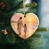 Christian Christmas ornament showing Jesus holding a little girl's hand by the sea