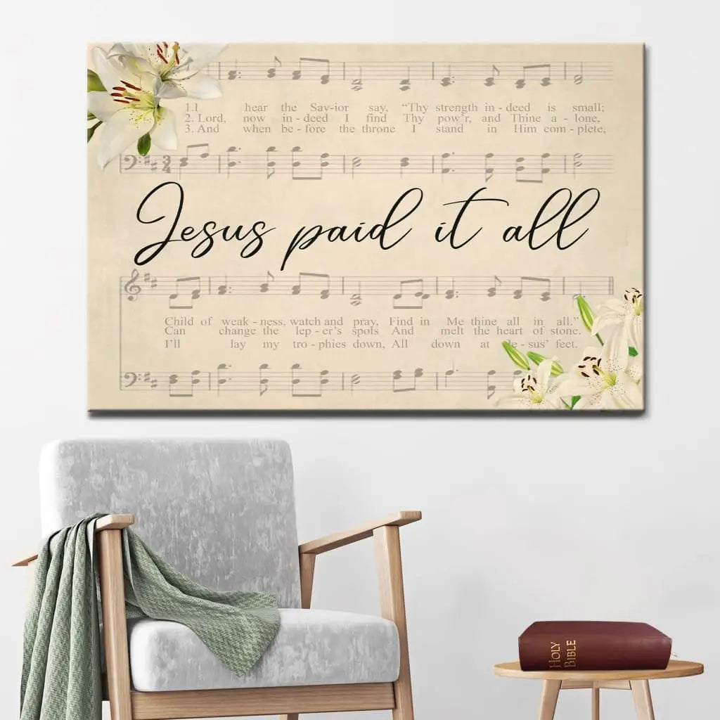 Christian wall art with &quot;Jesus Paid It All,&quot; featuring sheet music and lilies, perfect faith-based decor.