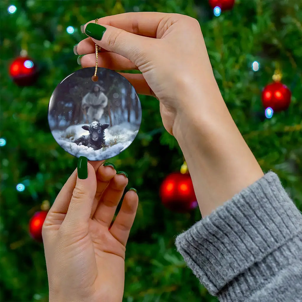 Inspirational ornament with Jesus rescuing a lost sheep in snow, perfect for Christian gifts.