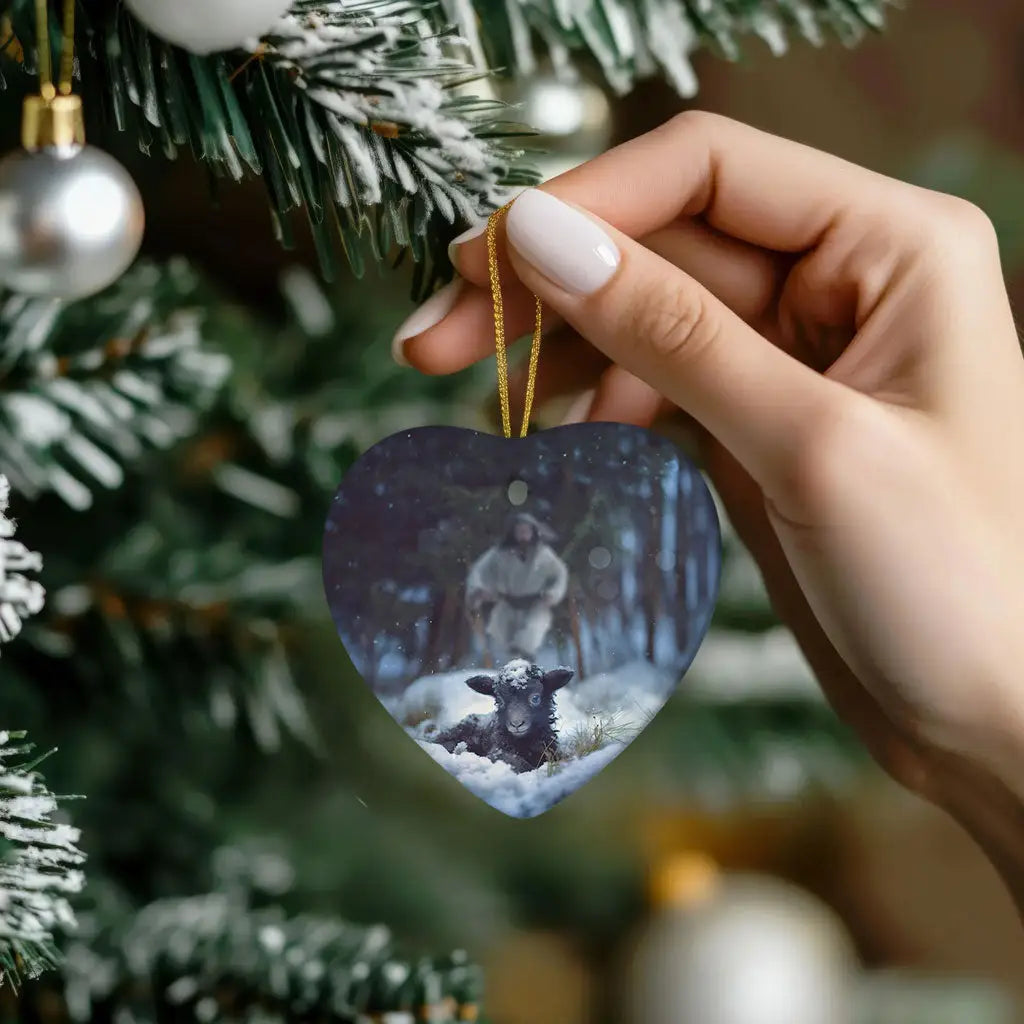 Christian holiday ornament showing Jesus running to a sheep in snow, ideal for faith-based gifts.