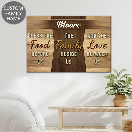Faith-based wall art canvas with "Bless the Food Before Us" and personalized family name, great for religious home decoration.