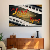 Christian wall art with Psalm 118:14, "The Lord is my strength and my song," featuring colorful lettering and piano keys on a wood background.