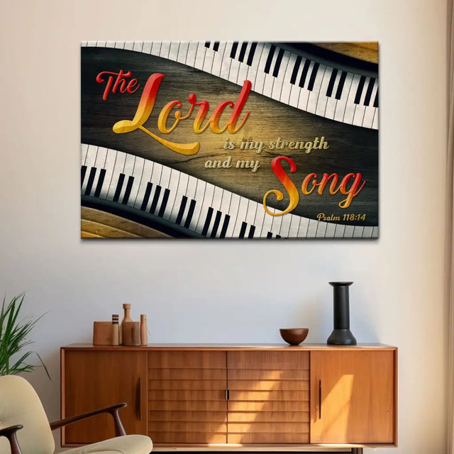 Christian wall art with Psalm 118:14, "The Lord is my strength and my song," featuring colorful lettering and piano keys on a wood background.