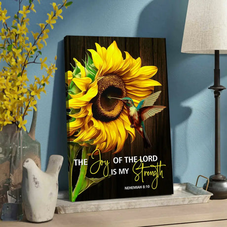 Inspirational canvas with Nehemiah 8:10, "The joy of the Lord is my strength," adorned with a bright sunflower and lively hummingbird.