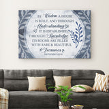 Christian wall art canvas featuring the verse "By Wisdom A House Is Built" adorned with a beautiful leaf border.