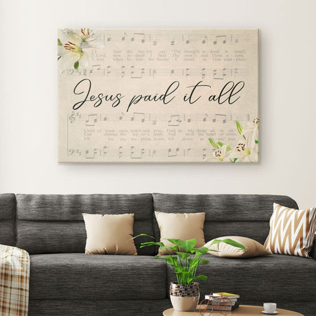 Jesus wall art featuring "Jesus Paid It All," with sheet music and lilies, perfect for religious home decor.