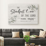 Christian canvas featuring Lamentations 3:22, "The steadfast love of the Lord never ceases," with a floral border, inspirational decor.