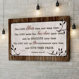 Christian wall art: Numbers 6:24-26 "The Lord Bless Thee and Keep Thee" with wooden border, rustic design.