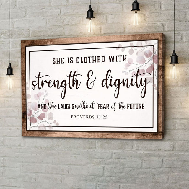 Proverbs 31:25 wall art with "She is clothed with strength & dignity," Christian decor with brown wooden border.